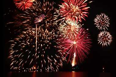 Fireworks explode over the lake in Farmers Branch during the Fourth Of July Spectacular....