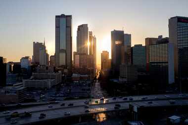 The sun sets behind the downtown Dallas skyline.  (Lynda M. Gonzalez/The Dallas Morning News)