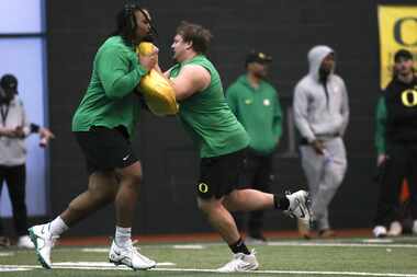 Oregon offensive linemen Steven Jones,left, and Jackson Powers-Johnson, right, at the...