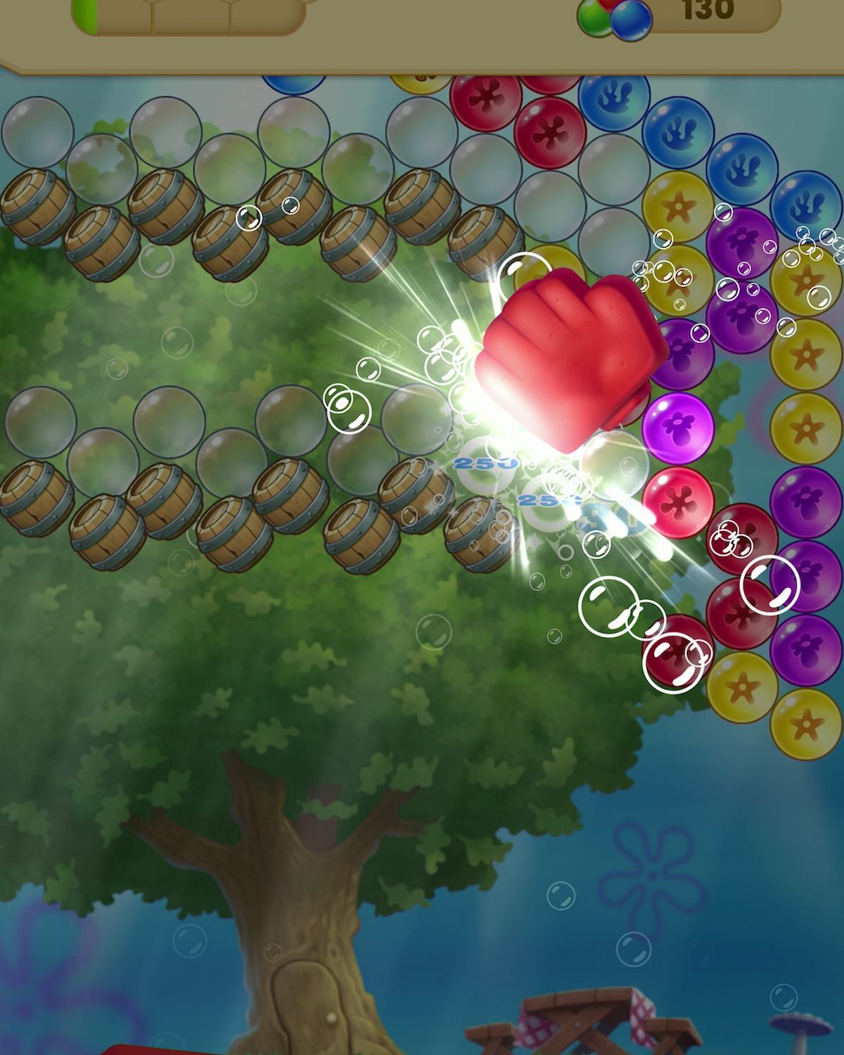 An in-game screenshot from the mobile game ‘SpongeBob: Bubble Pop F.U.N.,’ featuring bubbles bursting in the air