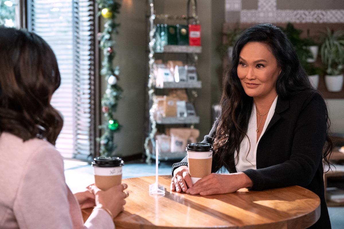 Tia Carrere as Dr. Logan in ‘Never Have I Ever’ Season 4 sits down at a coffee shop.