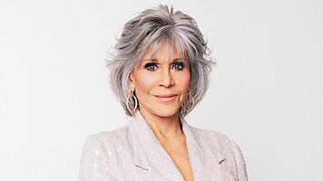 Headshot of Jane Fonda wearing a white sequin blazer