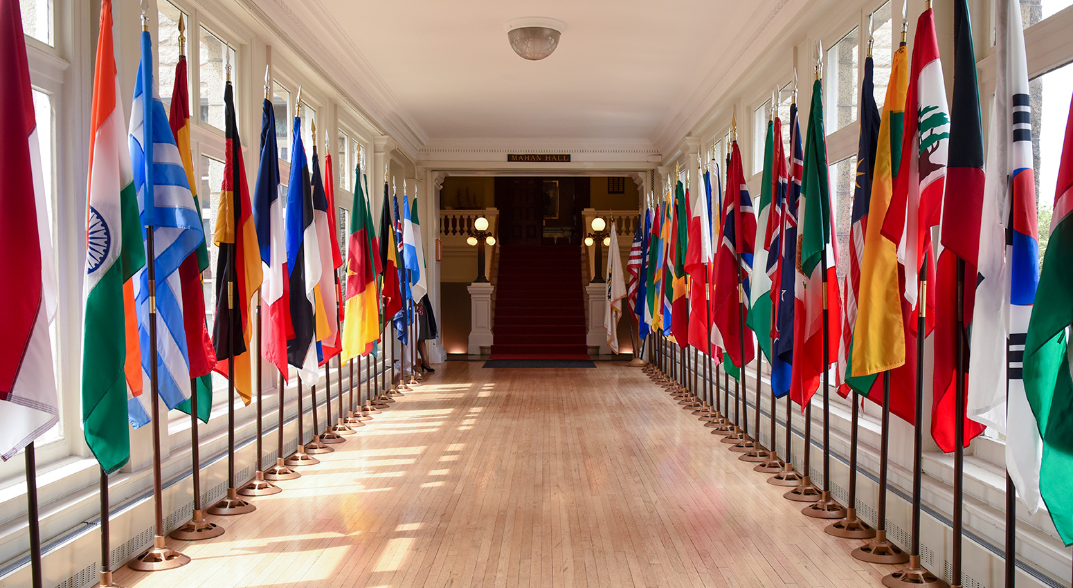 Different international flags down hallway at U.S. Naval War College