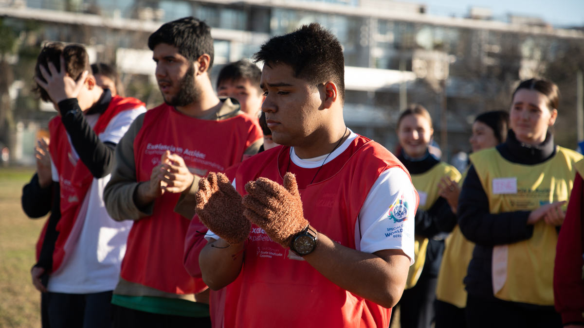 Athletes on a filed clapping