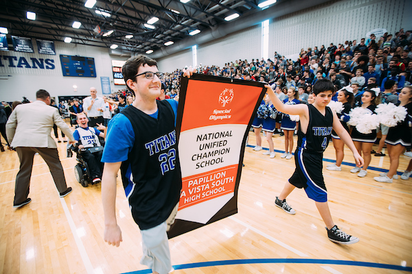 Students carry the Unified Champion School Banner at Papillion A Vista South High School