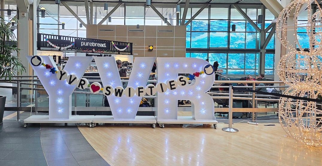 Taylor Swift-themed YVR sign and Christmas decorations at Vancouver International Airport in early December 2024. (Kenneth Chan/Daily Hive)