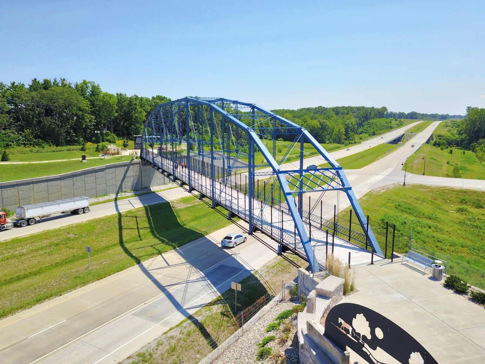 blue pedestrian walkway bridge constructed over highway in Delphi, Indiana