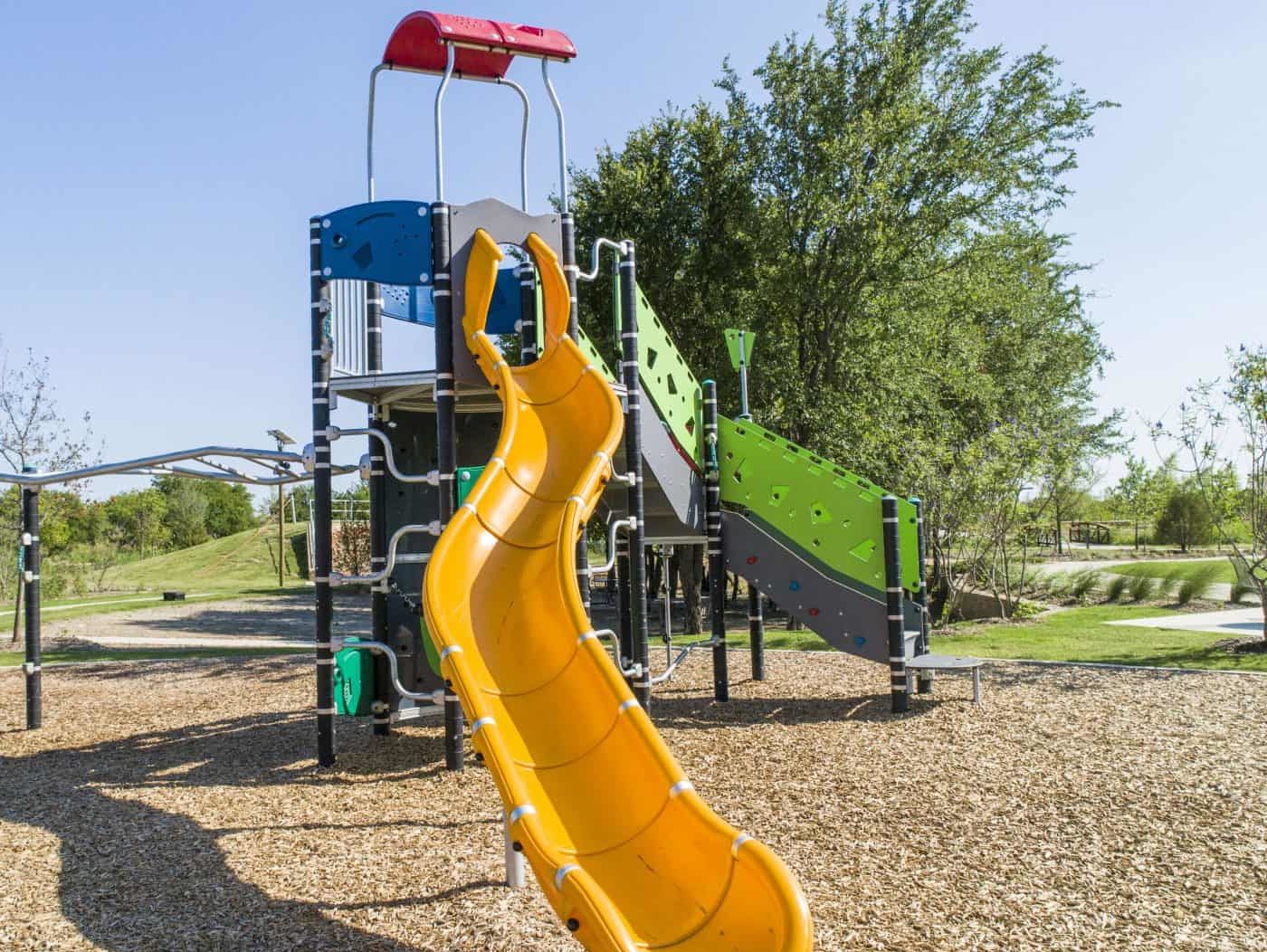 low altitude drone photo of yellow slide on playground in Celina, Texas