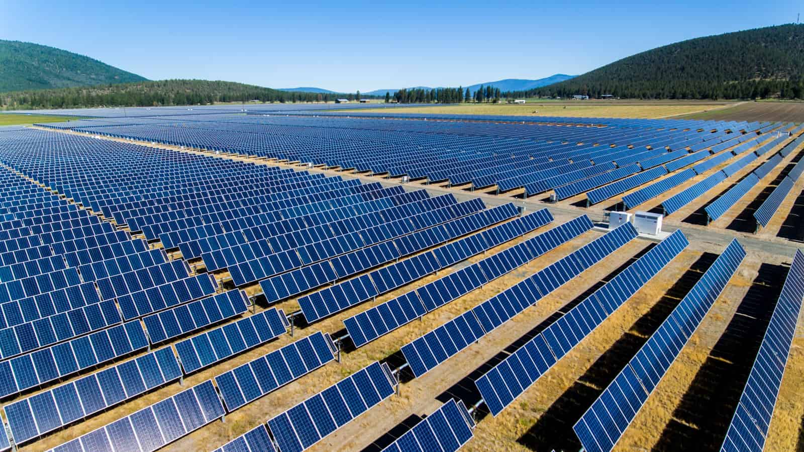 solar panels in field in Oregon angled at sun drone photo