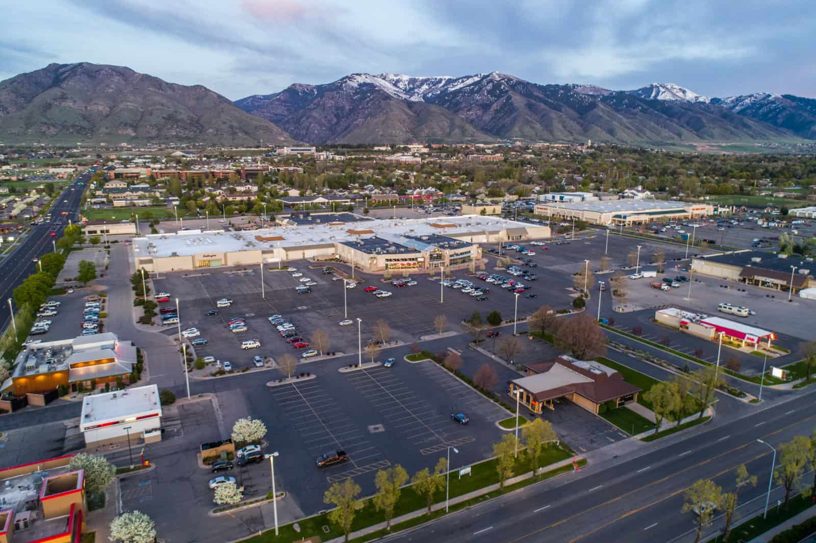 drone photo of shopping center in Utah with mountains in background