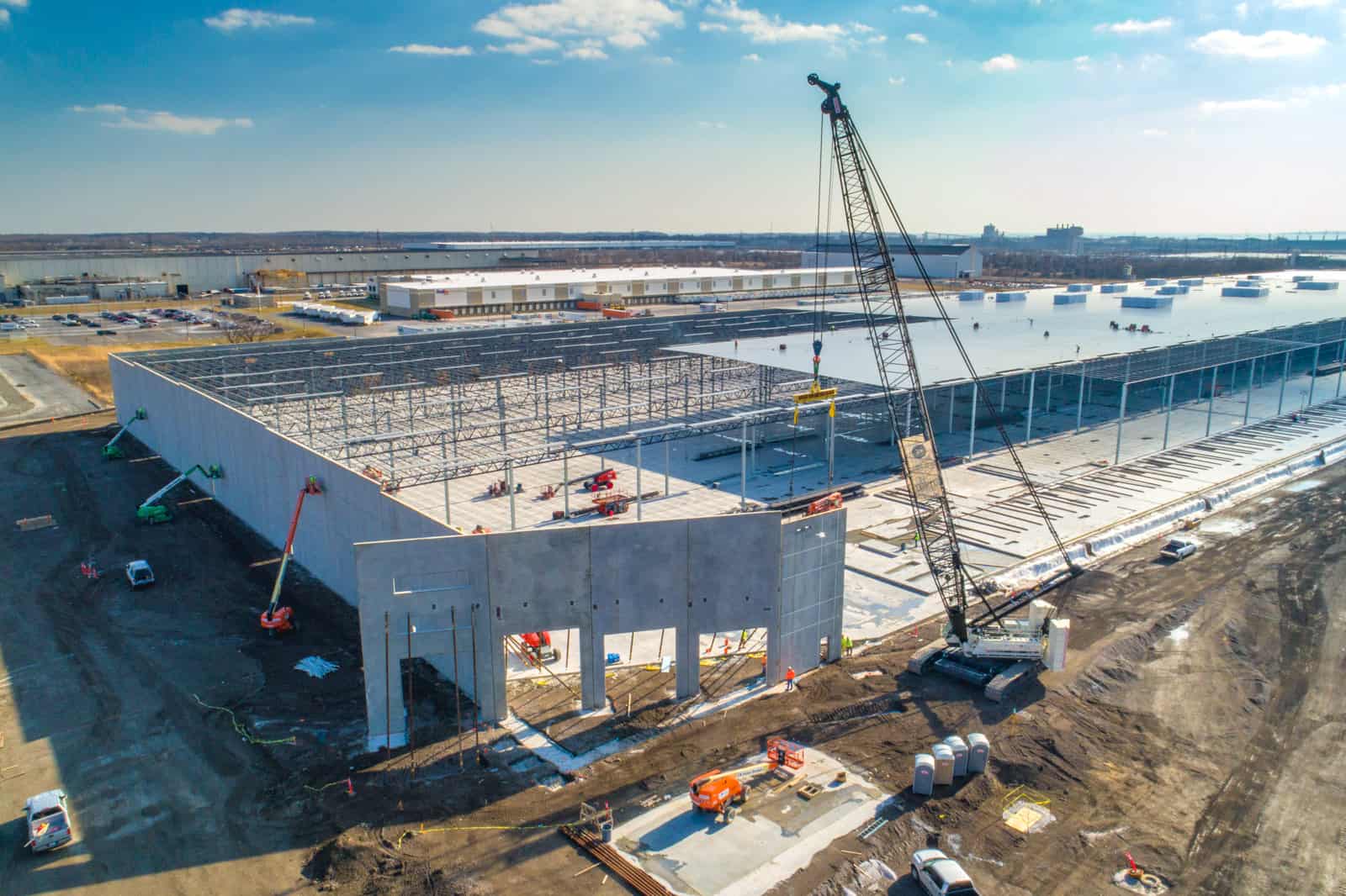 drone photo of crane installing new wall of massive commercial building in Maryland