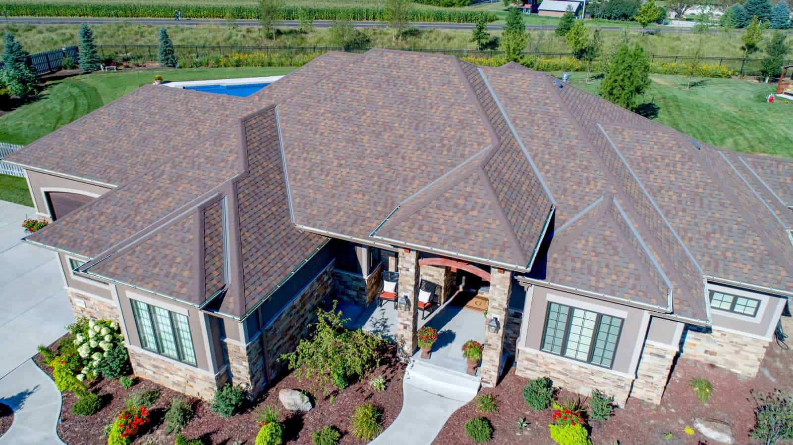 drone photo of home in Nebraska with swimming pool in backyard