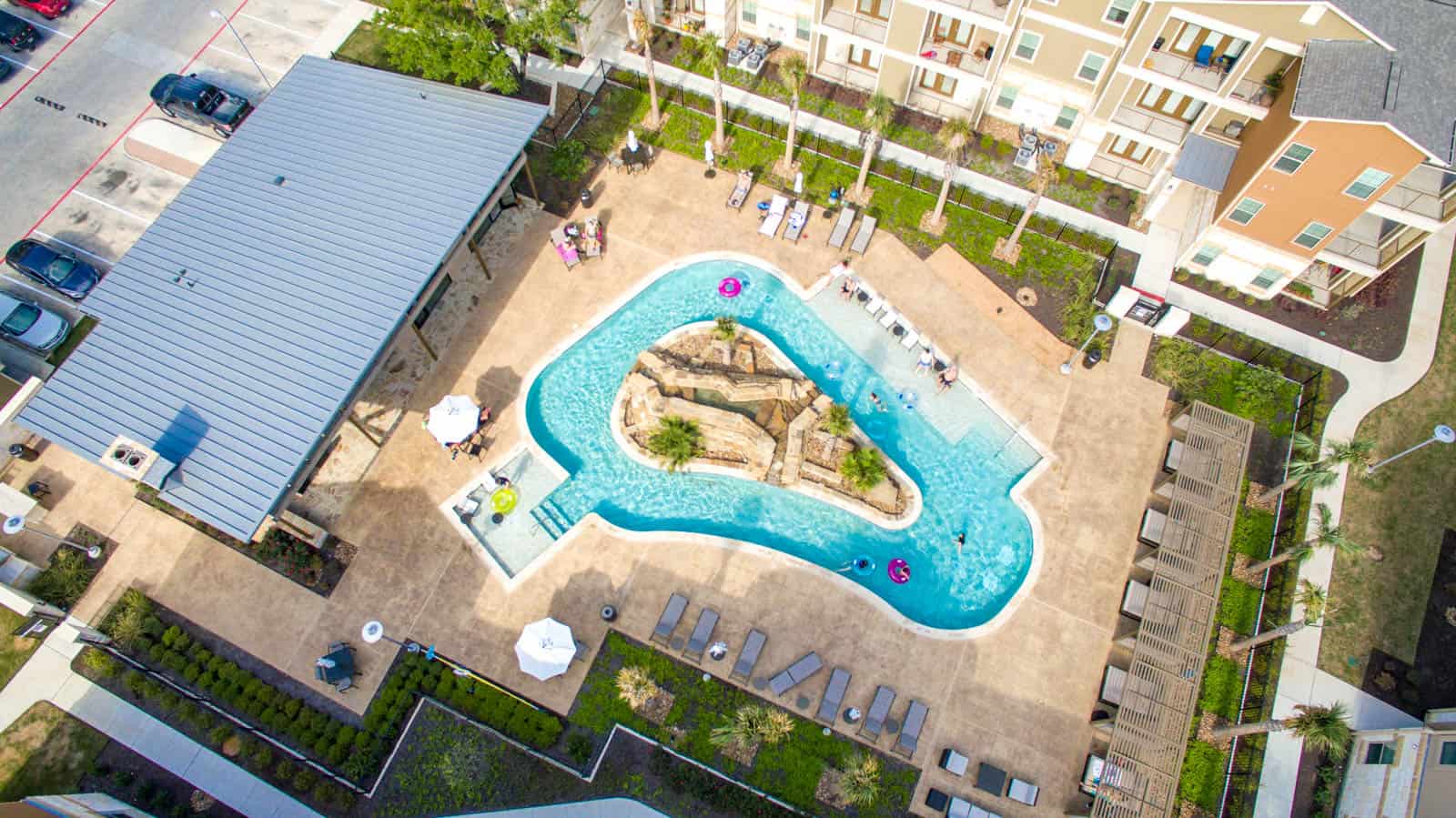 aerial drone photo looking down at a pool in an apartment complex