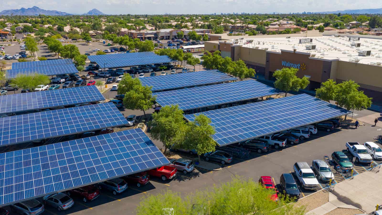 drone photo of solar panels shading parking spots in commercial strip mall in Glendale, AZ