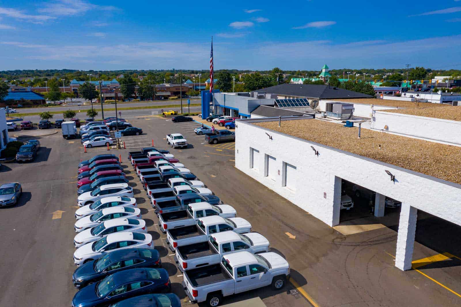 low altitude drone photo taken above cars parked in Chevrolet dealership lot in Sterling, VA