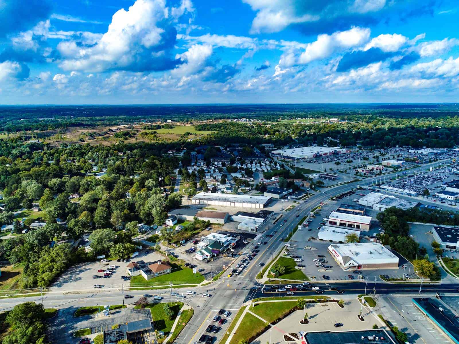 aerial drone photo of commercial real estate shopping plaza next to intersection in Grand Rapids, MI 