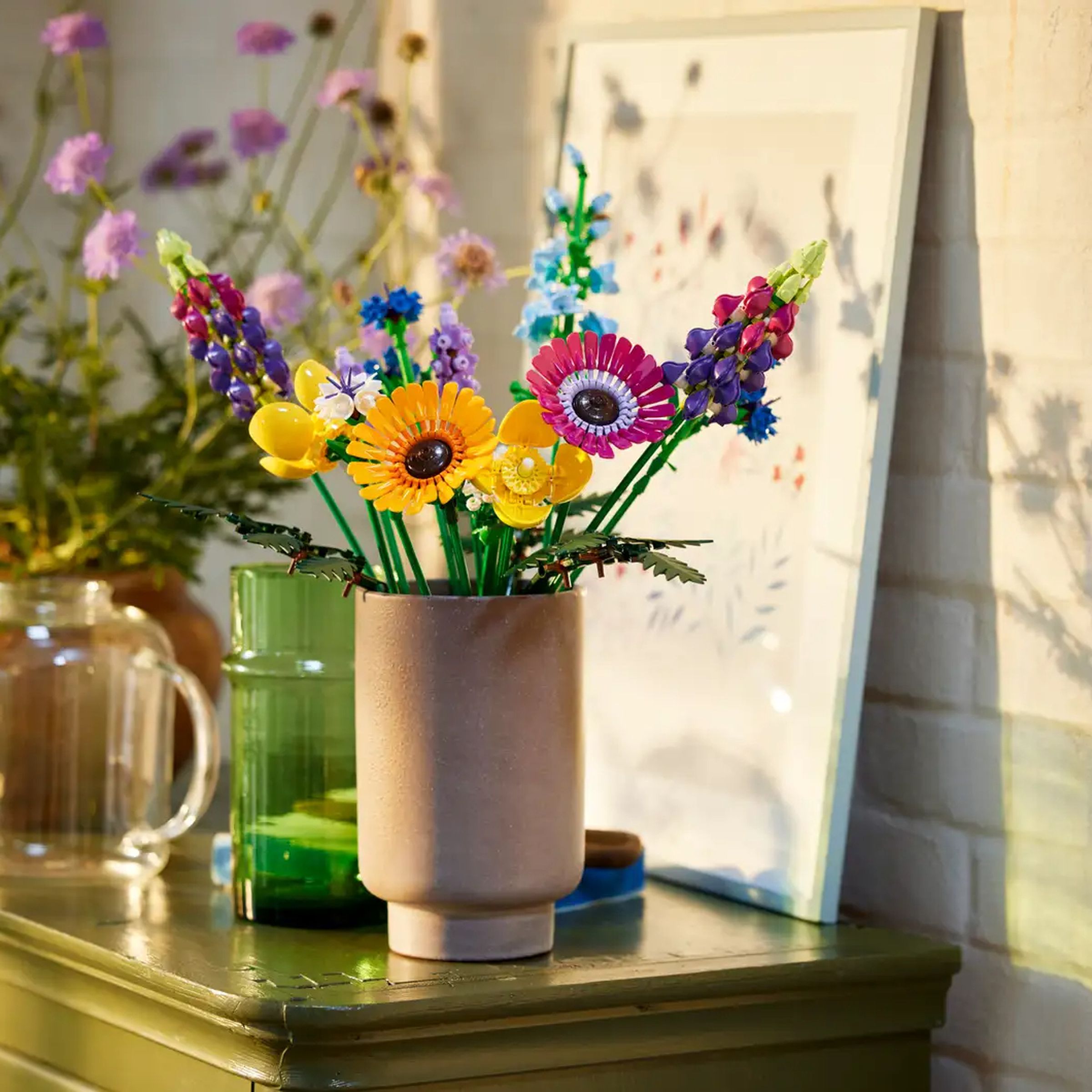 A wildflower bouquet made of Legos sitting on a cabinet.