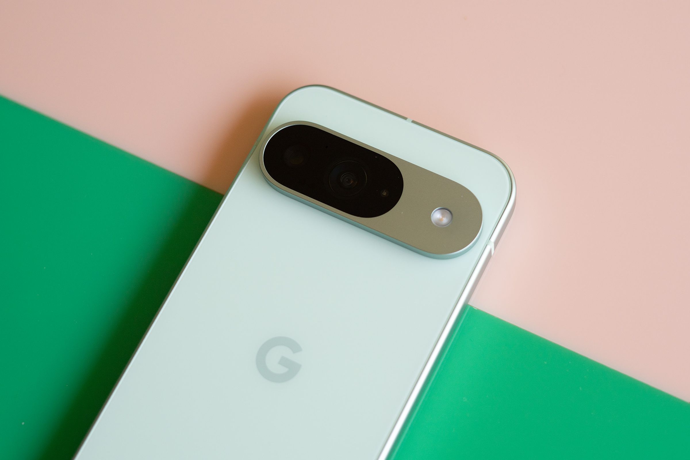 Google Pixel 9 on a pink and green background.