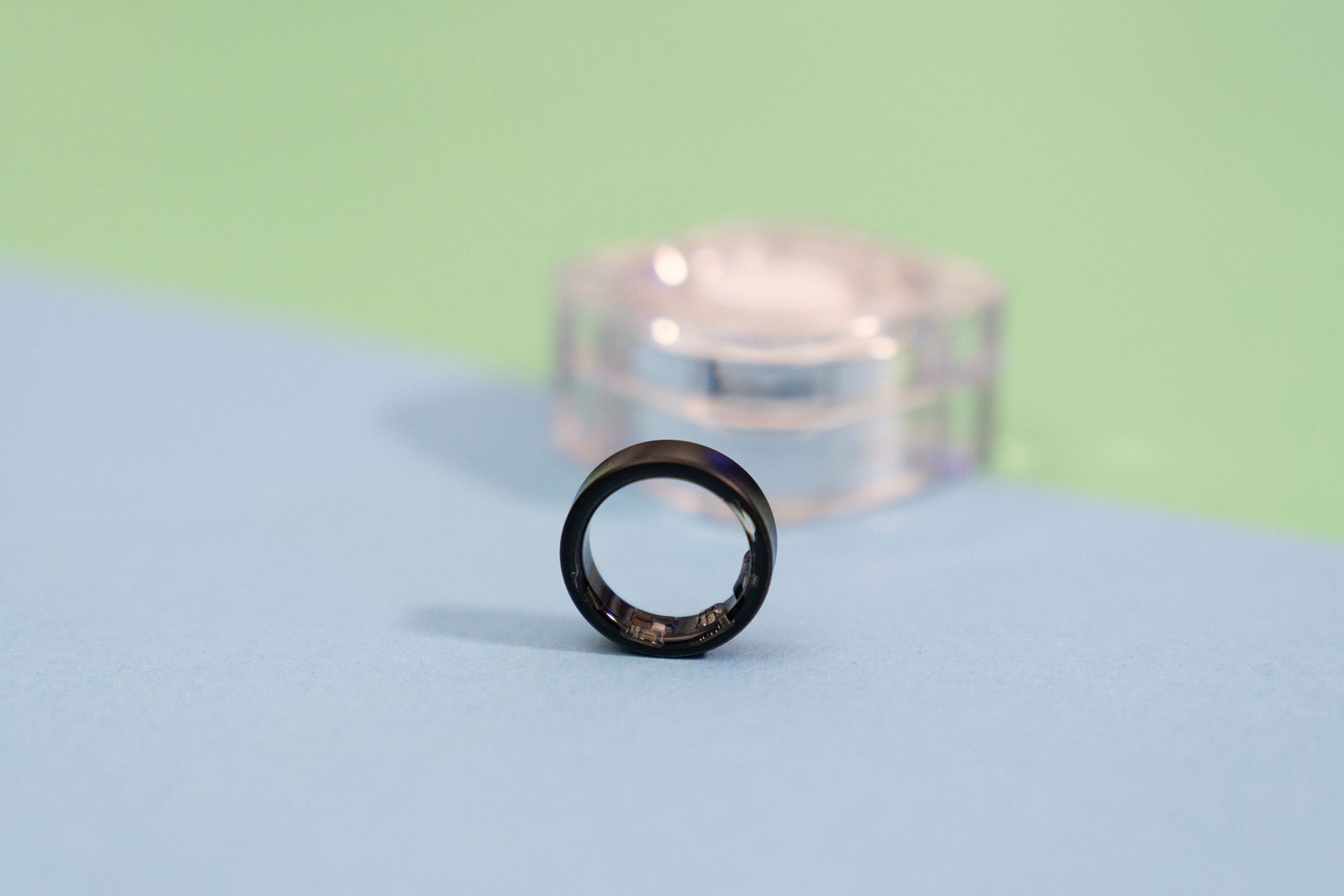 Close-up of Samsung Galaxy Ring with the case in the background