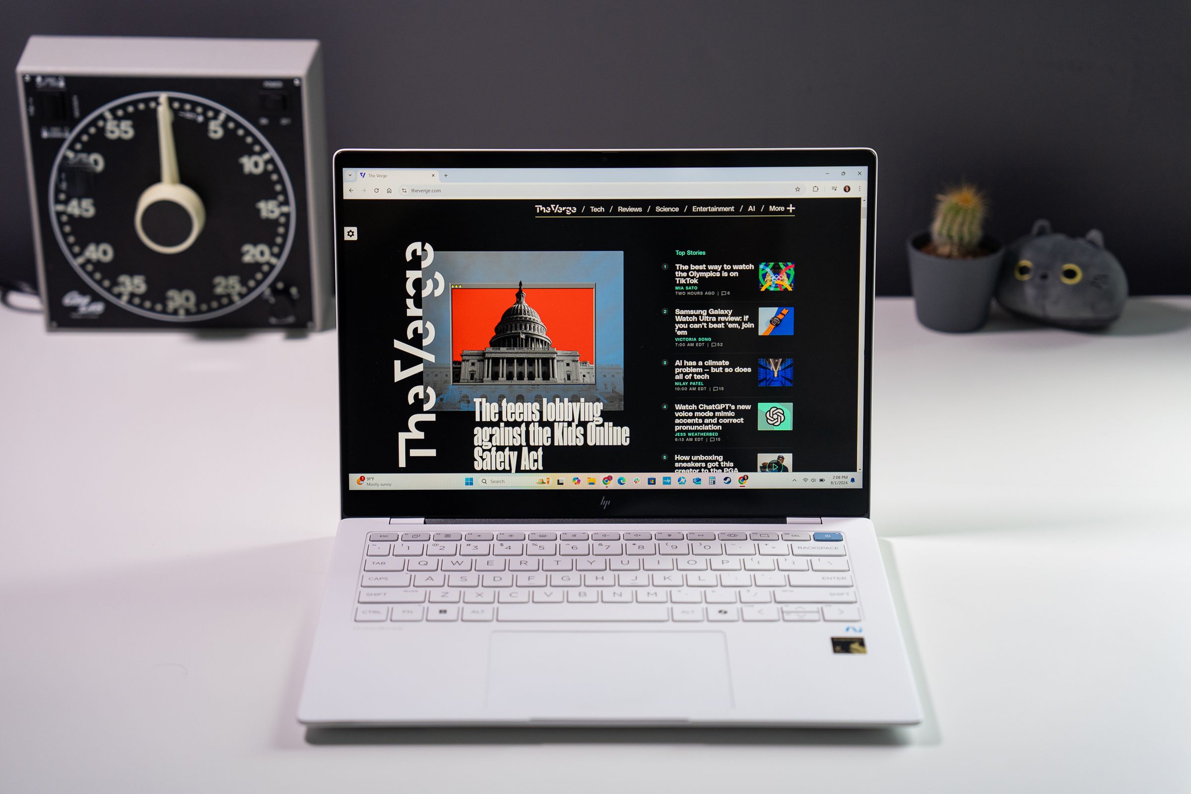 A white HP OmniBook X laptop sitting on a white tabletop in front of desk accessories.