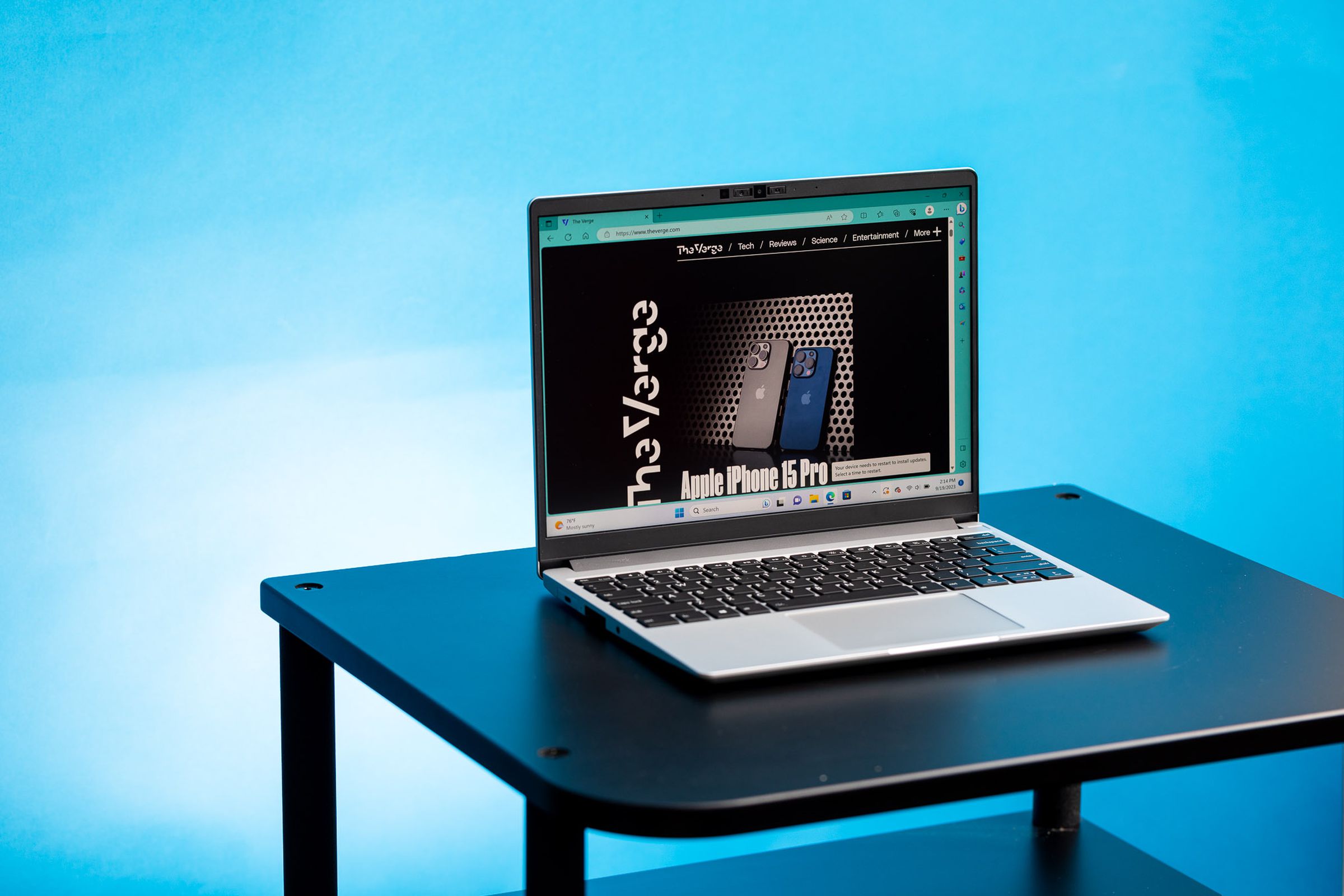 Framework Laptop 13 (AMD)displaying The Verge homepage, angled right on a table.