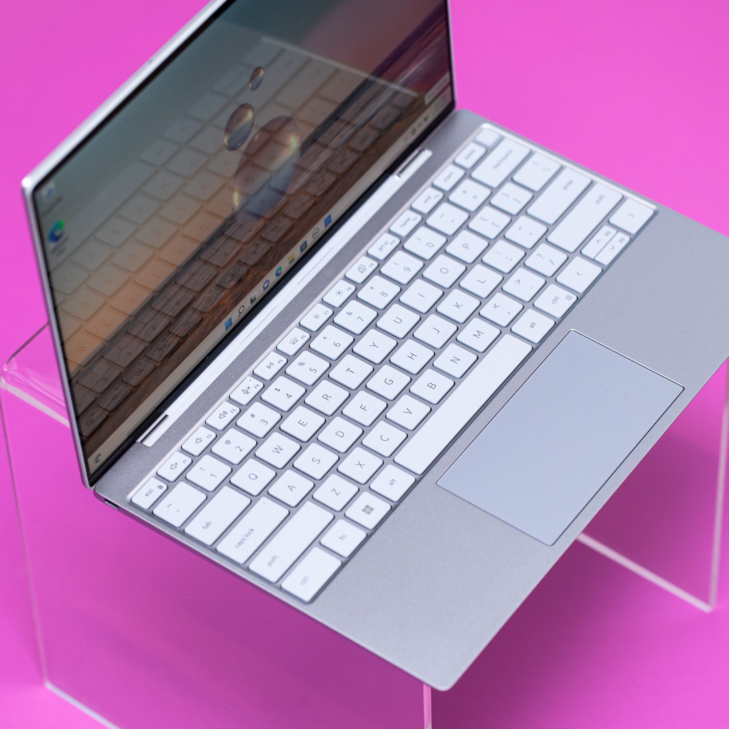 Best Laptop 2023: Dell XPS 13 on a pink surface seen from above.