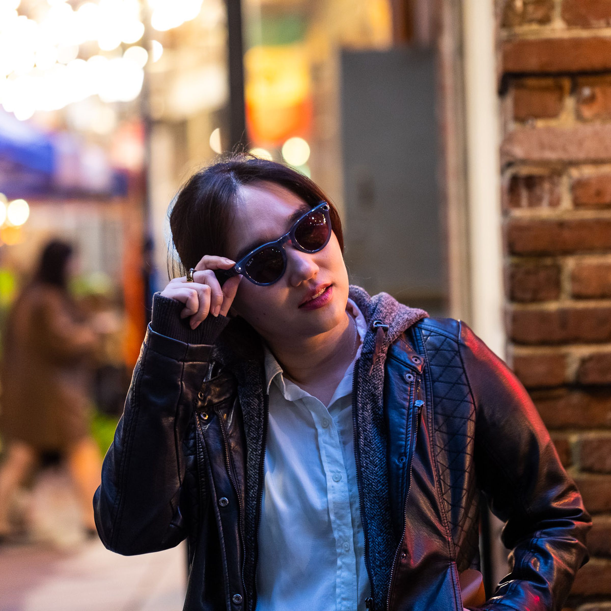 A person wearing Ray-Ban Meta Smart Glasses on a busy street.