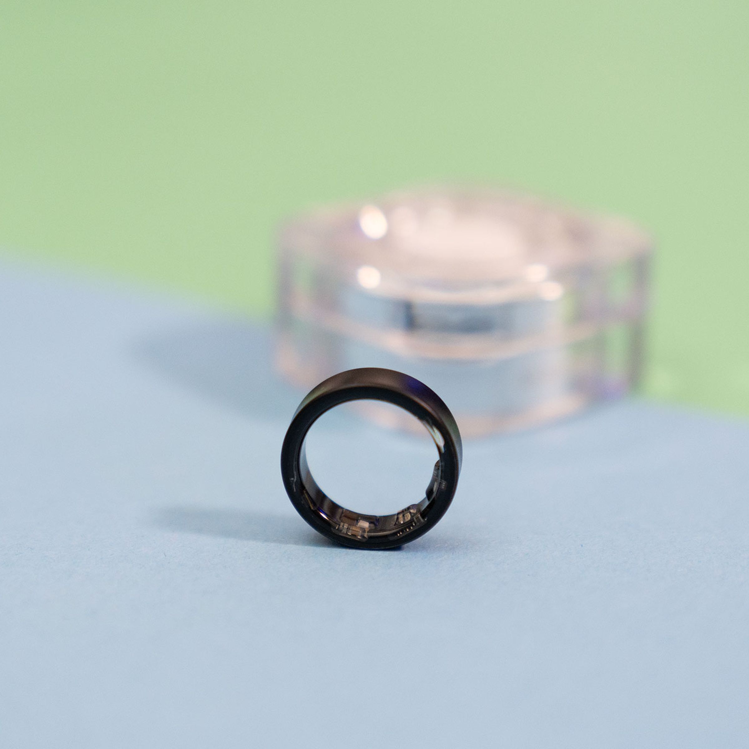 Close-up of Samsung Galaxy Ring with the case in the background