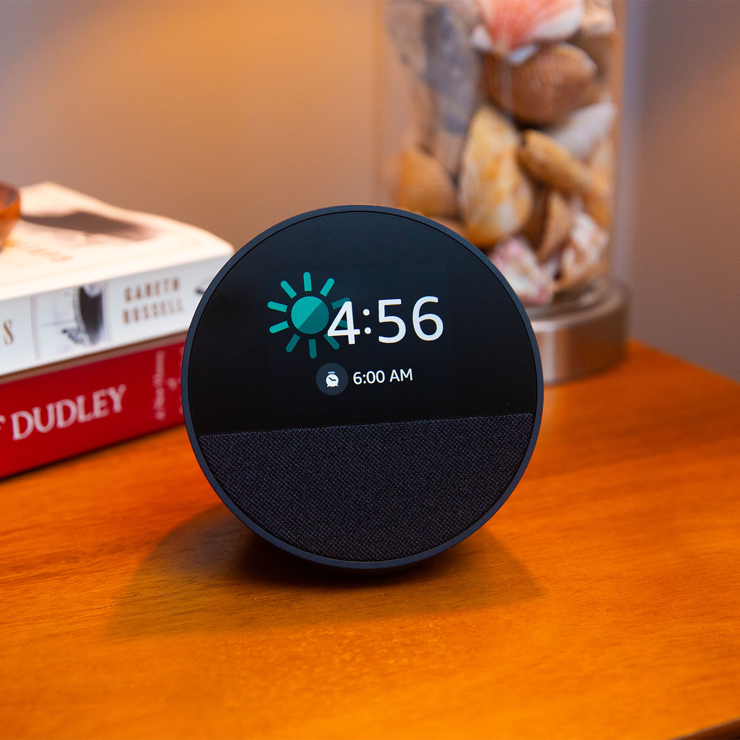 Photo of an Echo Spot sitting on a nightstand.