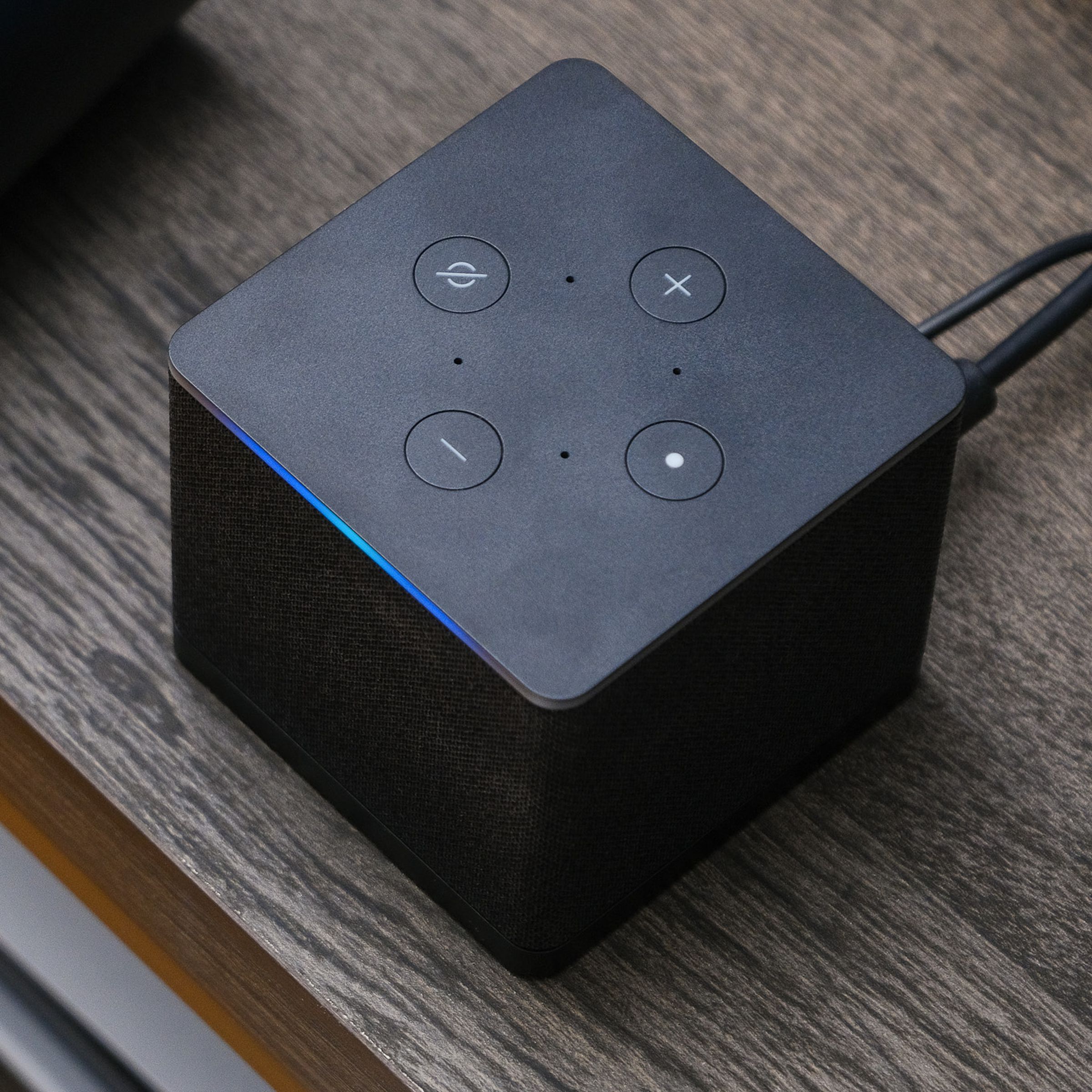 A photo of Amazon’s Fire TV Cube on a TV stand.