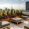 rooftop terrace with tables, chairs and planters