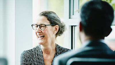 Women laugh in front of the Man and seems enjoying their conversation