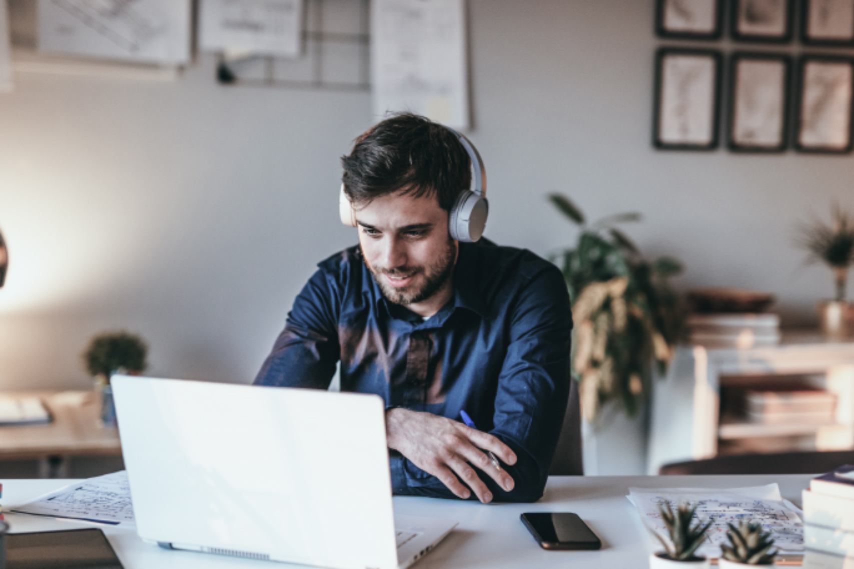 WFH Man Wearing Headset Holding Pen