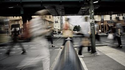 A group of people walking on a street in motion