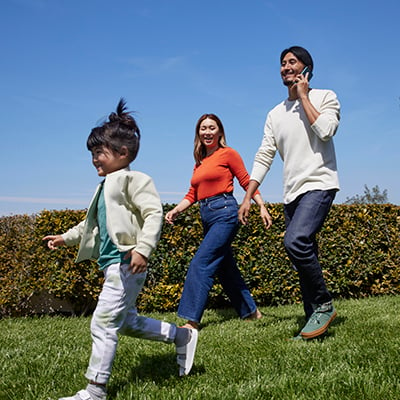 Family walking outdoors using mobile phone with Xfinity Mobile