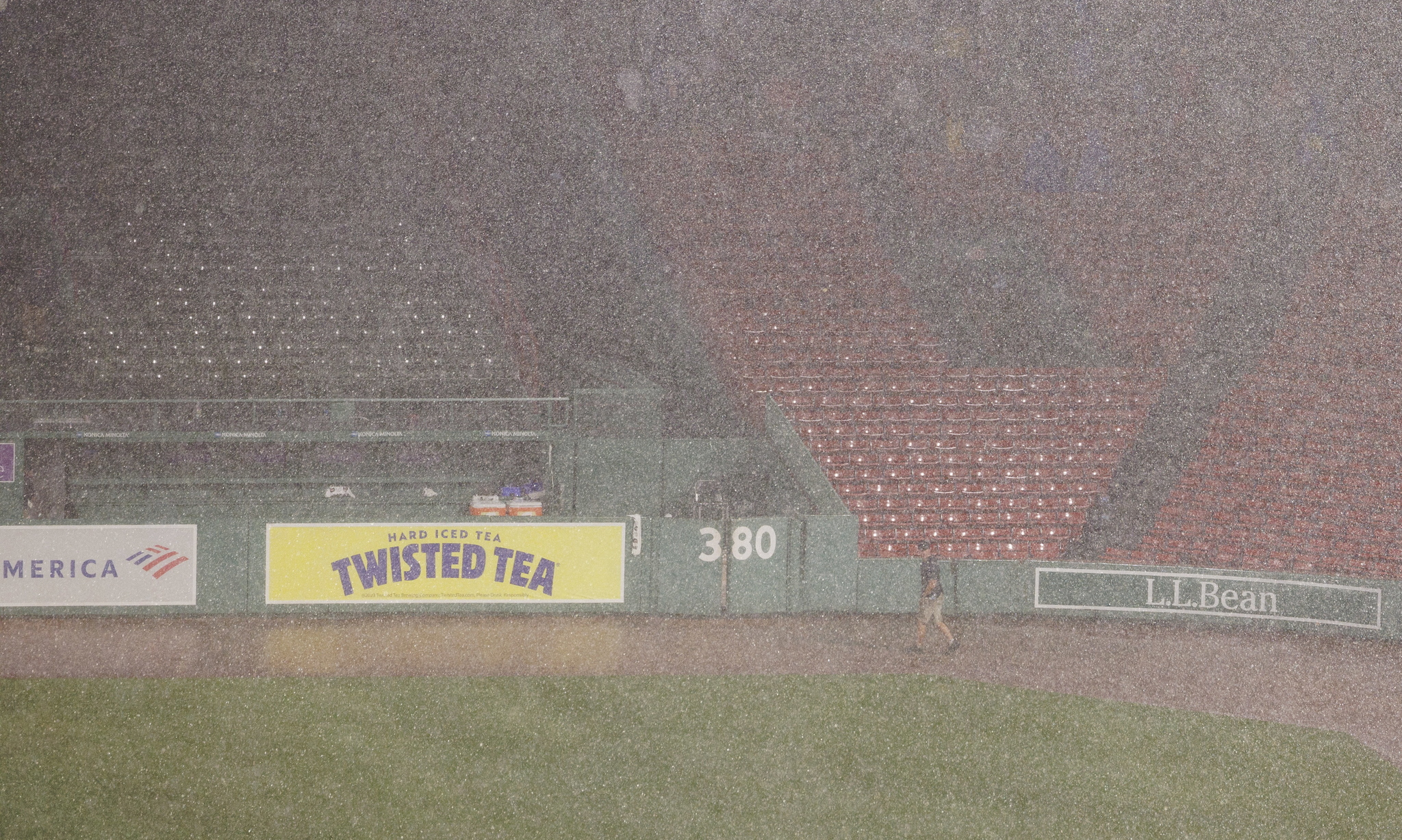 A Fenway Park security team member in right field as heavy rain falls