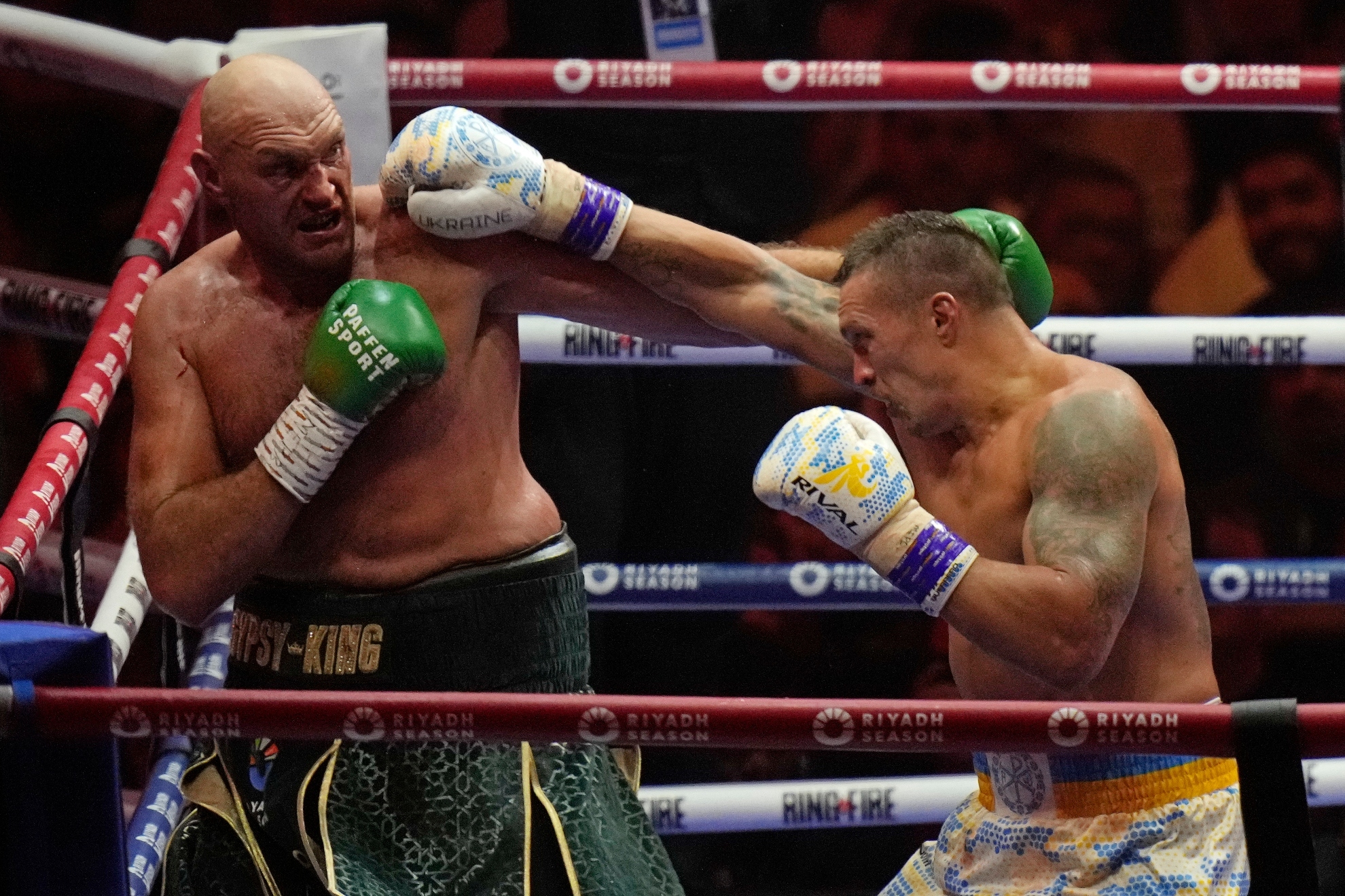 Britains Tyson Fury, left, and Ukraines Oleksandr Usyk trade blows during their undisputed heavyweight world championship boxing fight