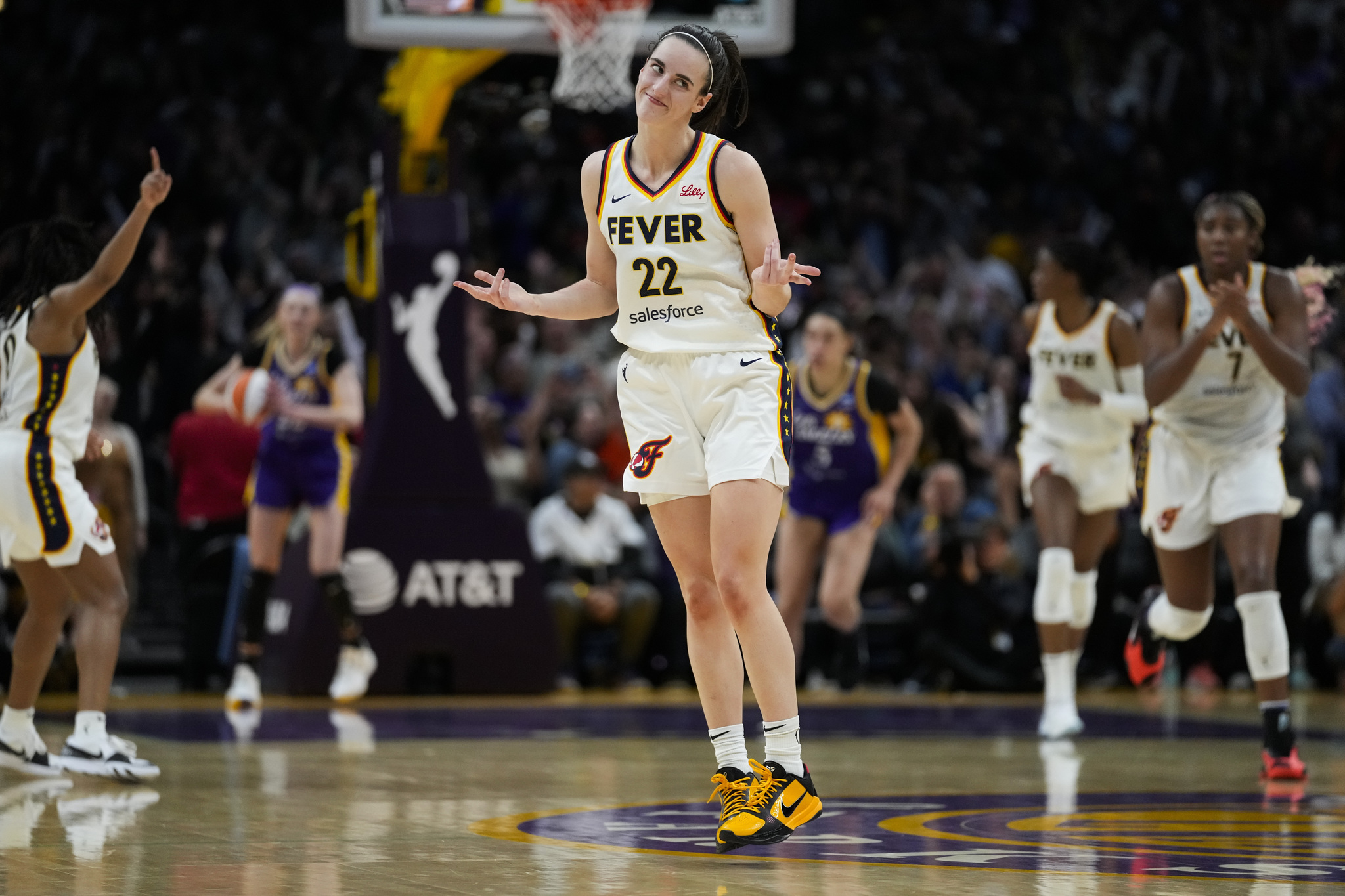 Indiana Fever guard Caitlin Clark (22) celebrates after making a 3-pointer during the second half of a WNBA basketball game