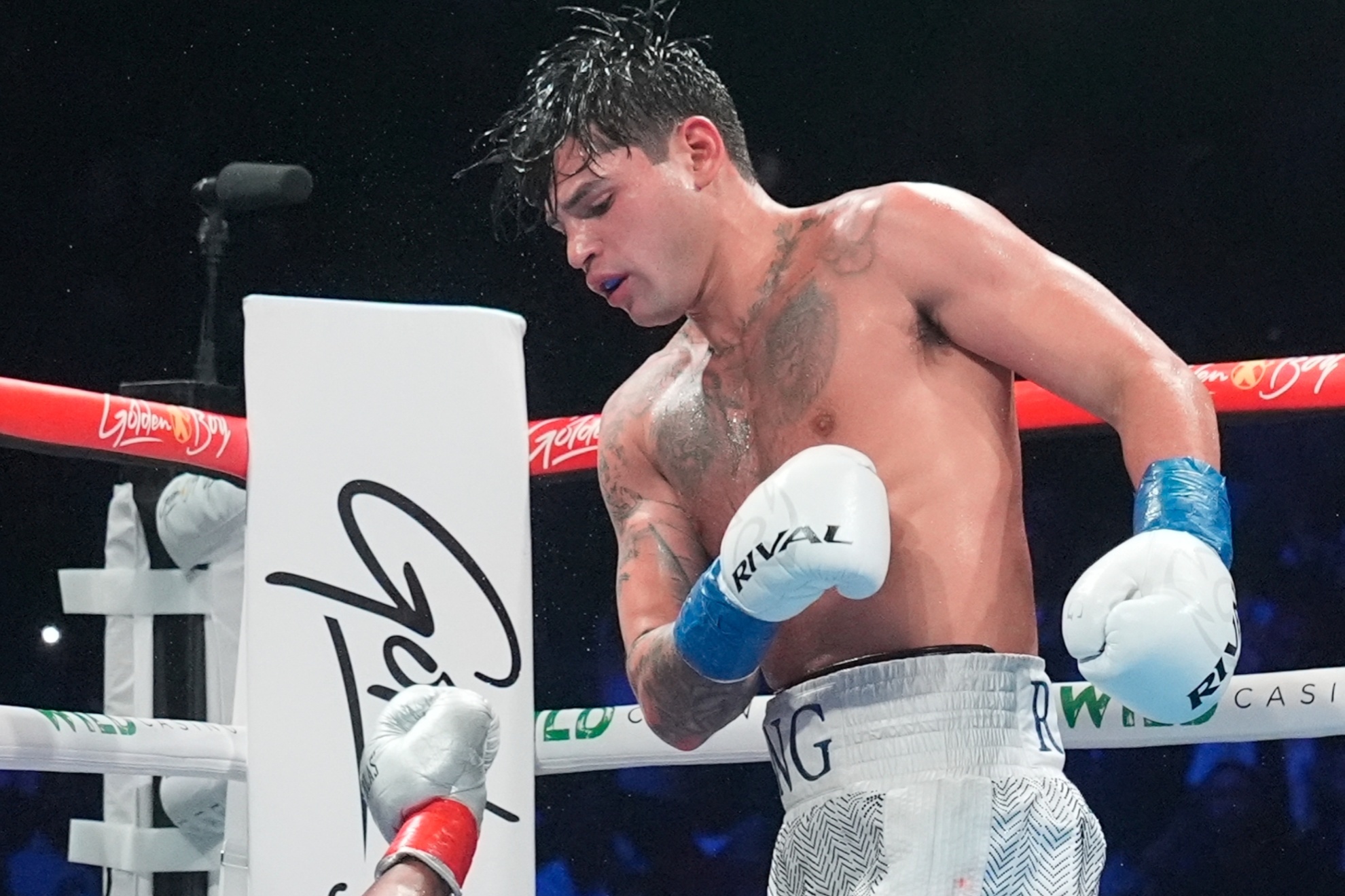 Ryan Garcia, right, knocks down Devin Haney during the 10th round of a super lightweight boxing match Sunday, April 21, 2024, in New York. Garcia won the fight. (AP Photo/Frank Franklin II)