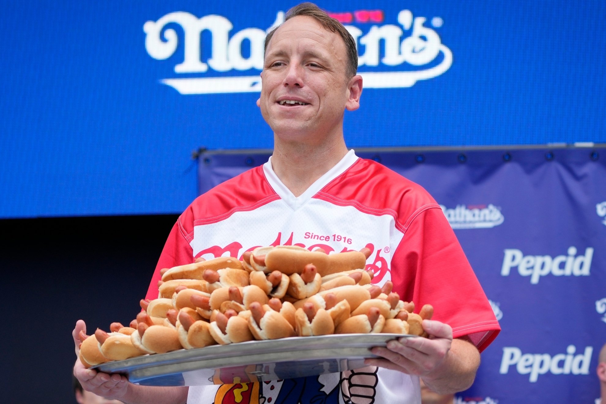 Why is Joey Chestnut banned from this years Nathans Hot Dog Eating Contest?