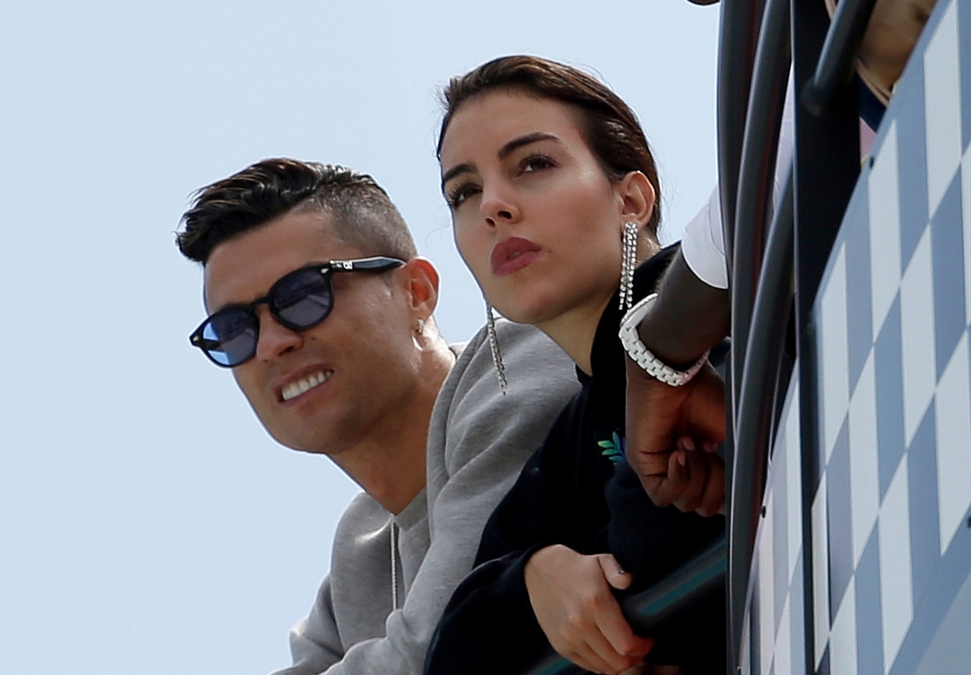 Cristiano Ronaldo, left, is flanked by his partner Georgina Rodriguez as they watch the second practice session for a Formula One race at the Monaco racetrack, in Monaco. Cristiano Ronaldo could be in trouble after apparently breaking coronavirus restrictions on a two-day trip to the mountains. The Juventus star and his partner Georgina Rodriguez spent Tuesday and Wednesday in Courmayeur in the Valle DAosta region in northwest Italy.