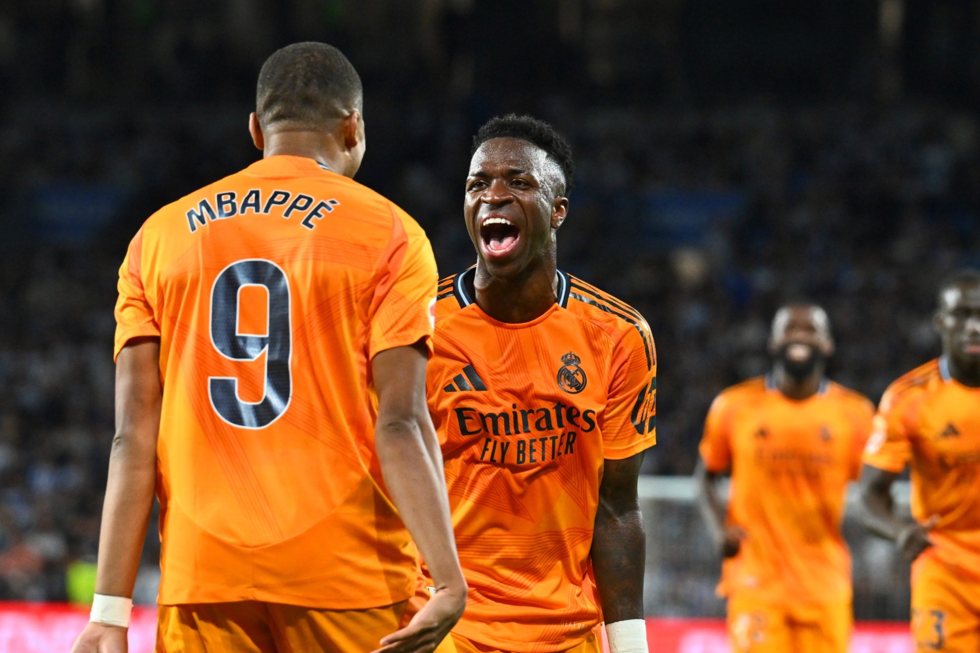 Real Madrids Kylian Mbappe celebrates with Vinicius Junior, 2nd left, after scoring his sides second goal from a penalty kick during a Spanish La Liga soccer match between Real Sociedad and Real Madrid at the Reale Arena in San Sebastian, Spain, Saturday, Sept. 14, 2024. (AP Photo/Miguel Oses)