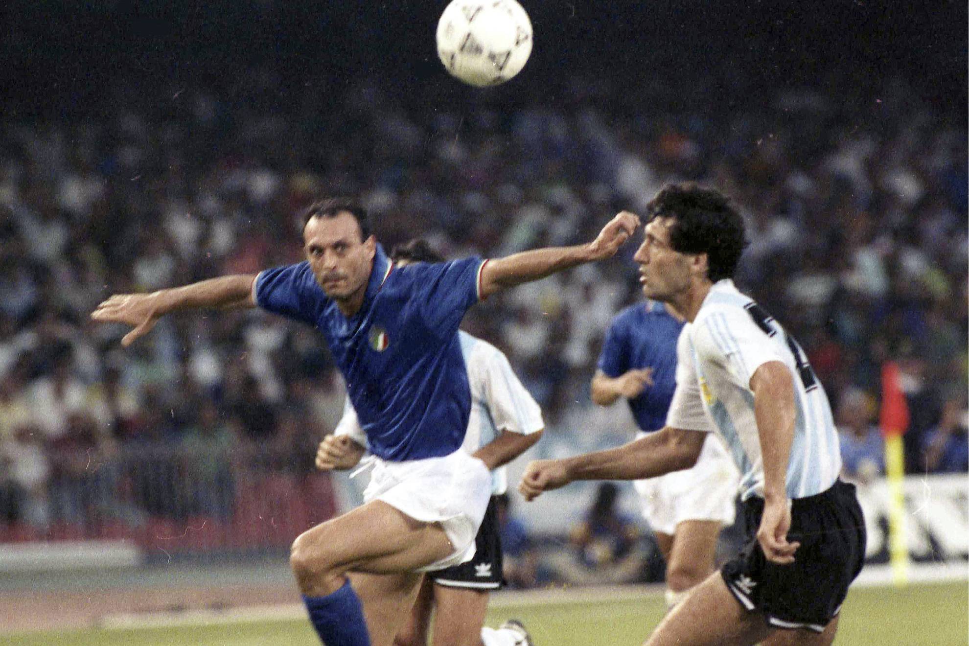 Italys Salvatore Tot� Schillaci, left, and Argentinas Juan Simon chase the ball during the Soccer World Cup semi-final, in Naples, Italy, July 3, 1990.