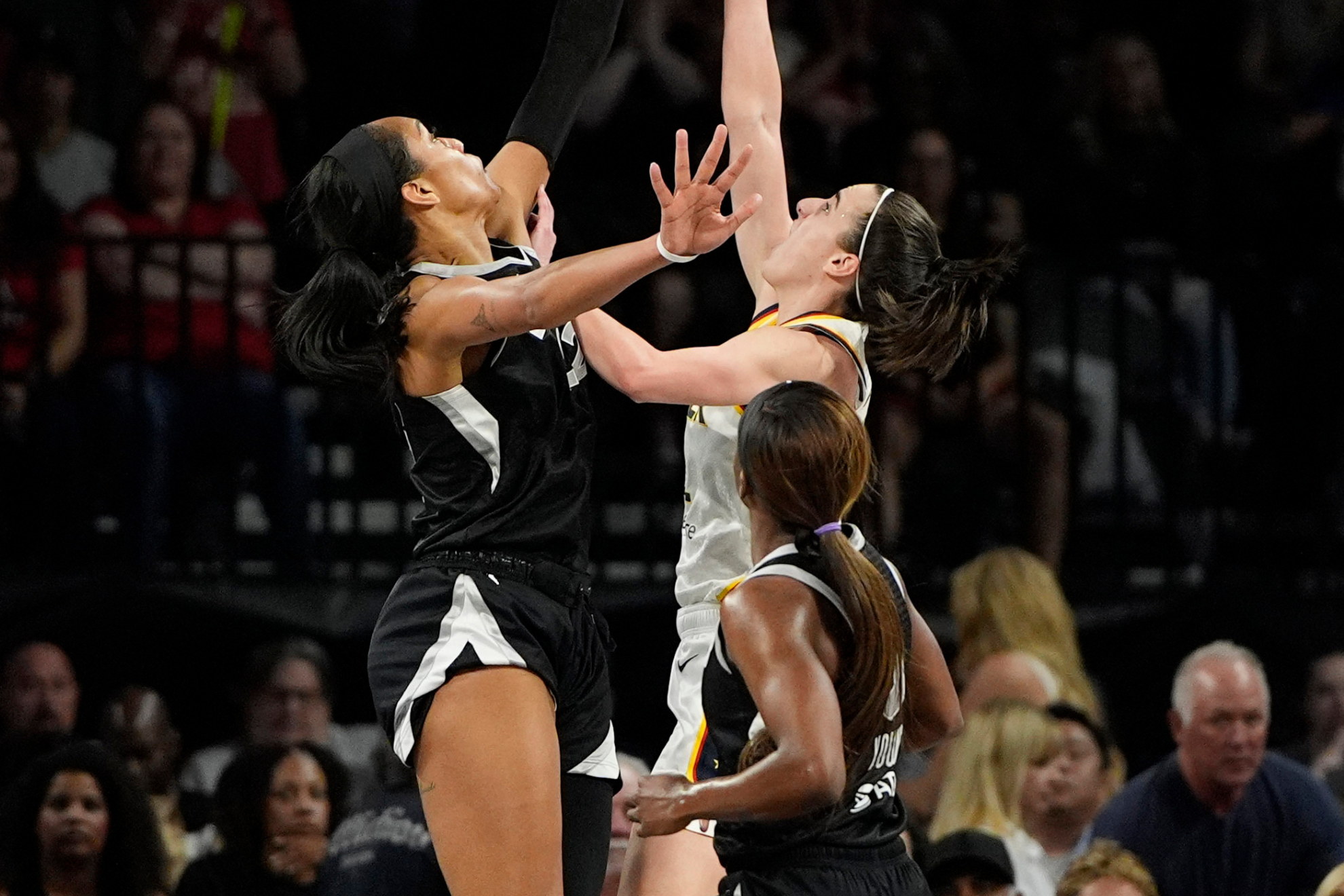 Aja Wilson meets Caitlin Clark at the rim during a WNBA game.