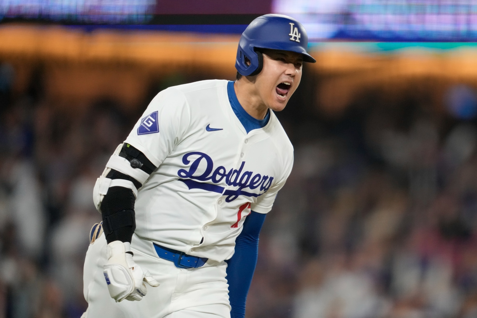 Los Angeles Dodgers designated hitter Shohei Ohtani reacts as he singles during the sixth inning of a baseball game against the San Diego Padres in Los Angeles, Wednesday, Sept. 25, 2024. Will Smith scored. (AP Photo/Ashley Landis)