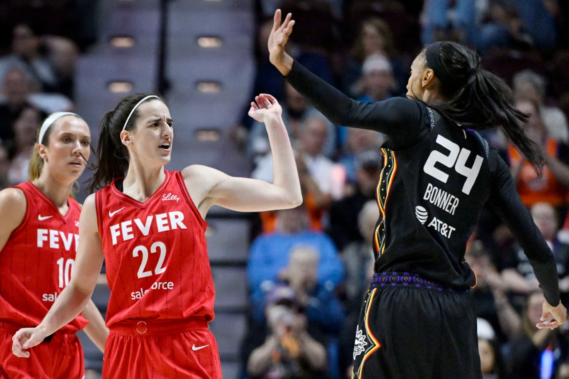 Caitlin Clark and Dewanna Bonner during a playoff game between the Fever and the Sun