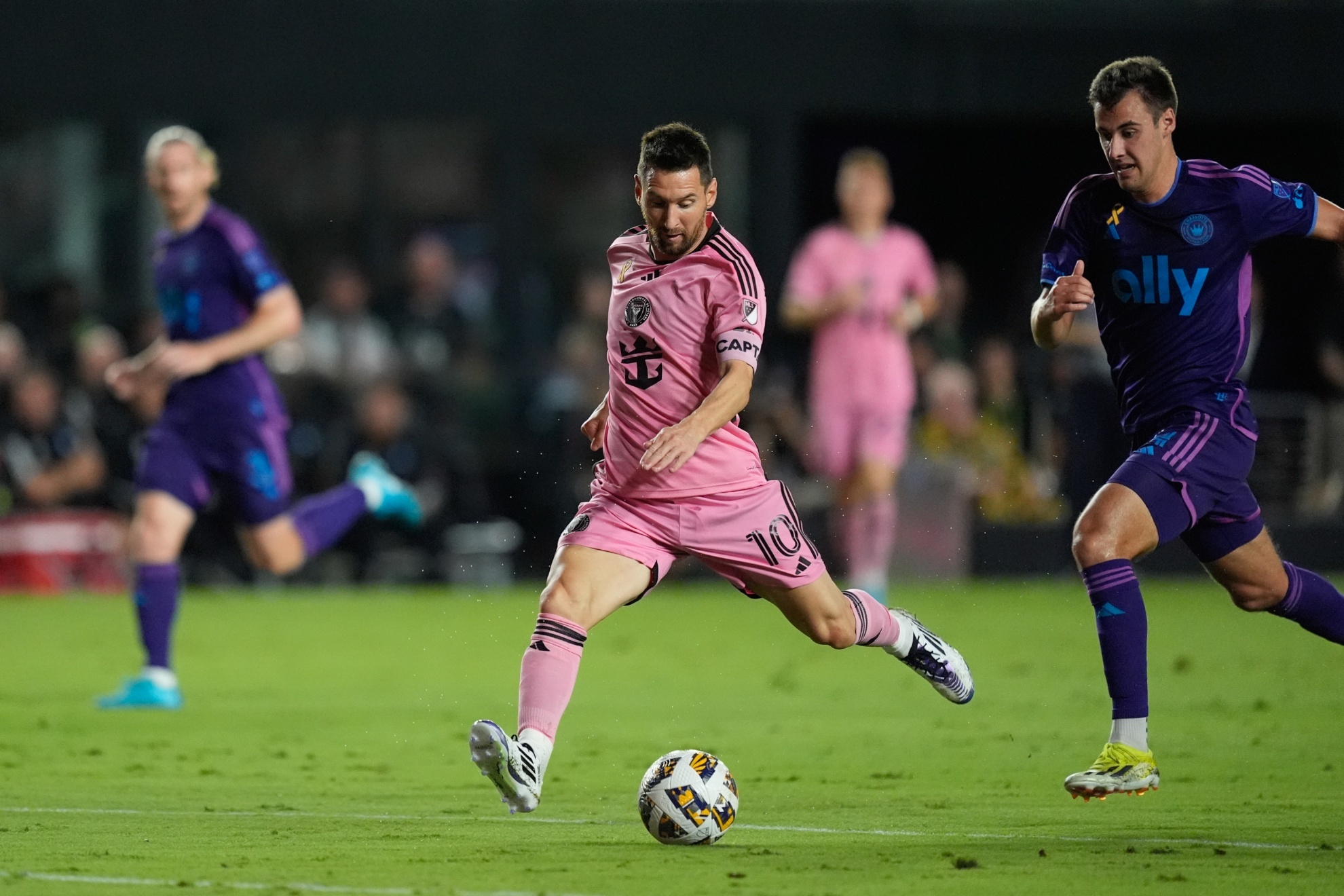 Inter Miami forward Lionel Messi (10) takes a shot, pursued by Charlotte FC midfielder Andrew Privett (34) during the first half of an MLS soccer match, Saturday, Sept. 28, 2024, in Fort Lauderdale, Fla. (AP Photo/Rebecca Blackwell)