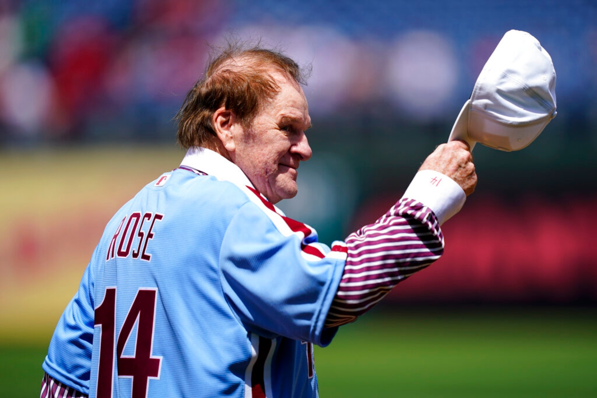 Former Philadelphia Phillies player Pete Rose takes his hat off to the fans.