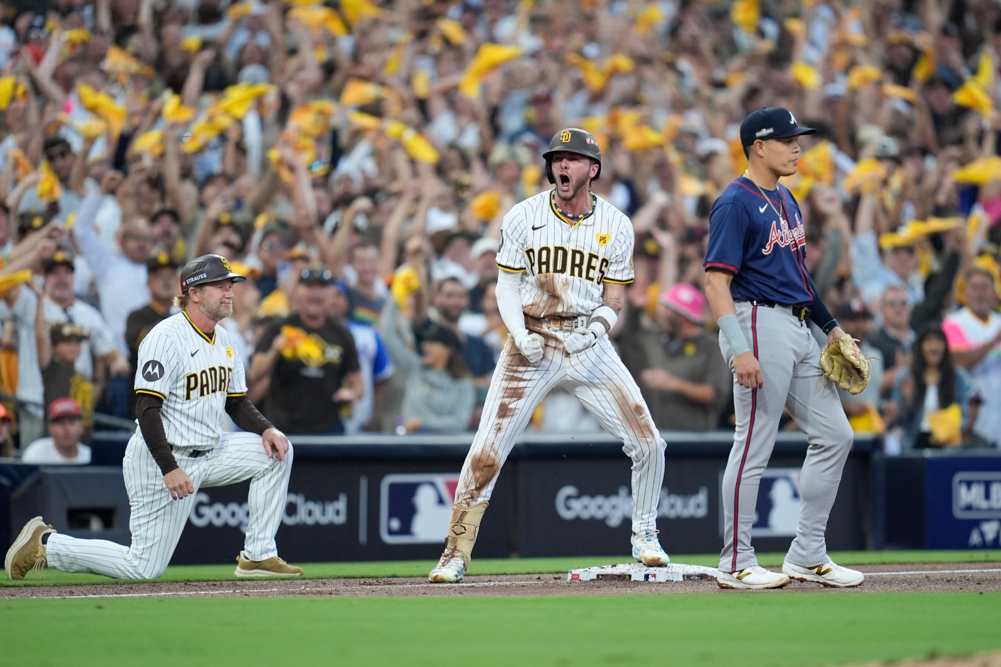 San Diego Padres Jackson Merrill, center, celebrates after driving in two runs with a triple during the second inning in Game 2 of an NL Wild Card Series baseball game against the Atlanta Braves, Wednesday, Oct. 2, 2024, in San Diego. (AP Photo/Gregory Bull)