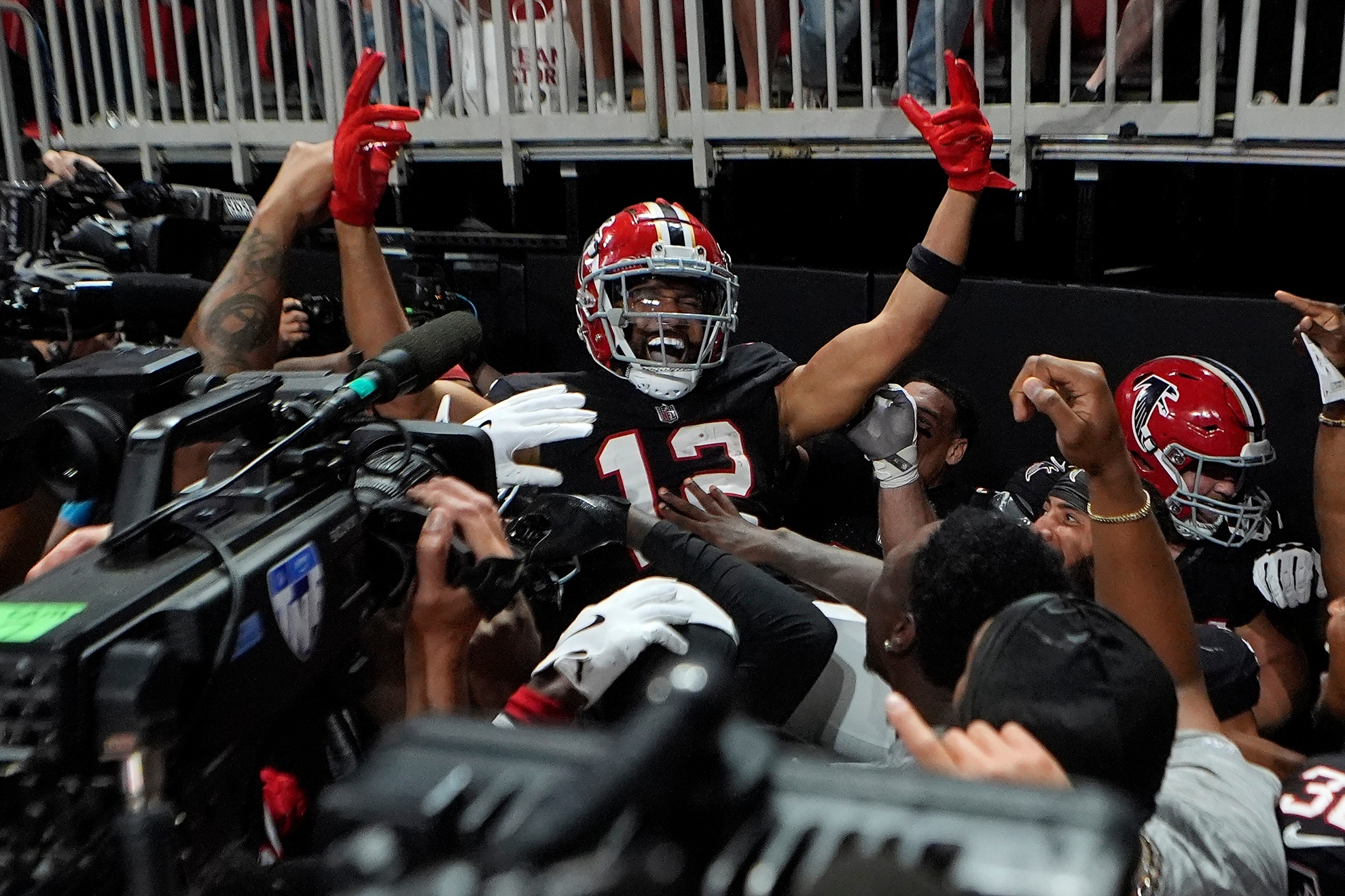 Atlanta Falcons wide receiver KhaDarel Hodge (12) celebrates after scoring the game-wining touchdown against the Tampa Bay Buccaneers during overtime in an NFL football game Thursday, Oct. 3, 2024, in Atlanta. (AP Photo/John Bazemore)